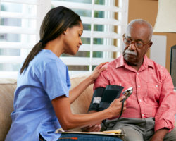 caregiver getting the blood pressure of patient